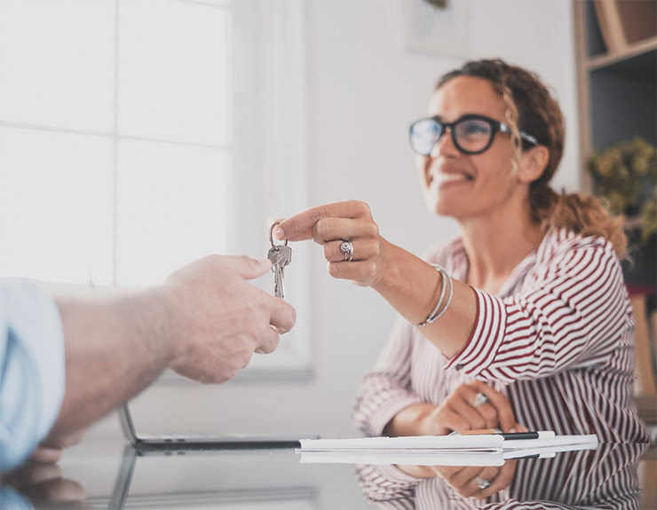 handing keys to first time homebuyer