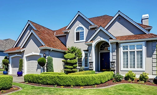 house with a green front lawn