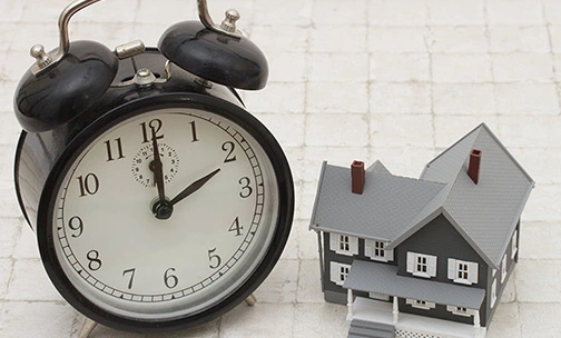 alarm clock and house on the table
