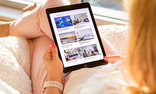 woman looking at homes on her tablet