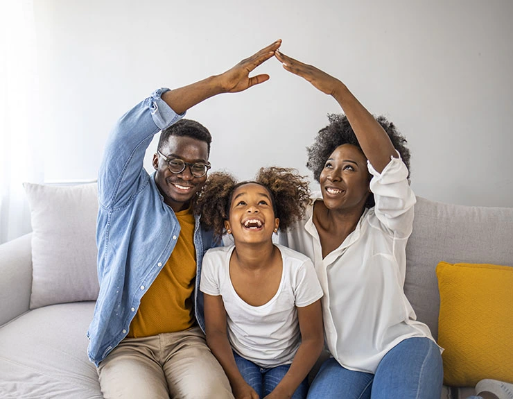 Concept of housing and relocation. Happy family mother father and kids with roof at home. New building residential house purchase apartment concept. Concept housing young family.