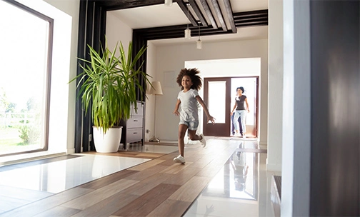 young girl running in big house