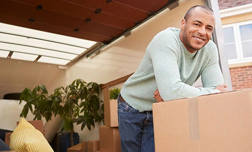 man leaning on cardboard box