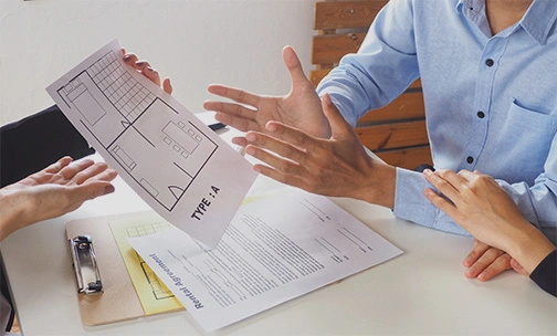 couple looking at floor plan with agent