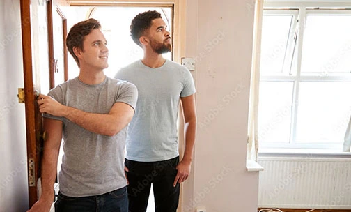 two men looking inside a home