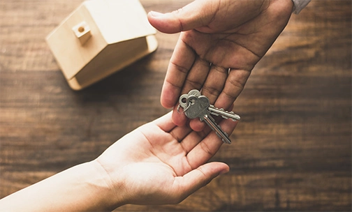 agent handing key to new homeowner