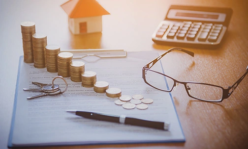 Mortgage contract for sale of real estate property with a pen and house keys