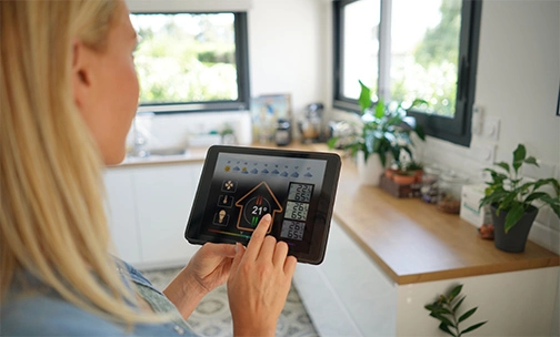woman using smart home thermostat