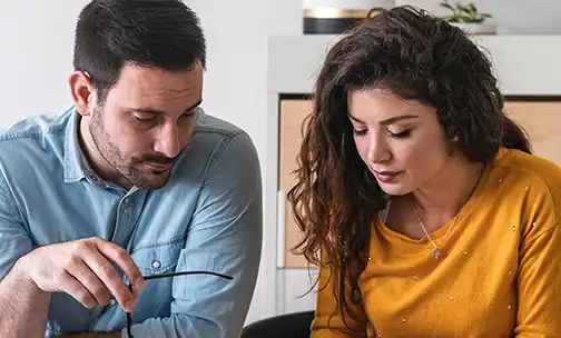 Young couple calculating their domestic bills at home stock photo