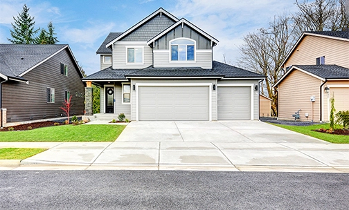 street view of home with a white garage