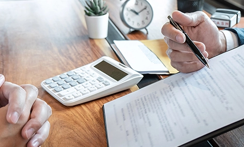 people at desk looking at contract