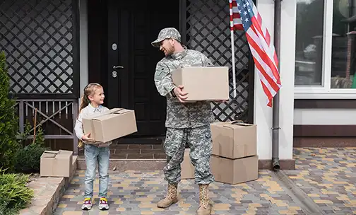 American soldier and his kid carrying moving boxes