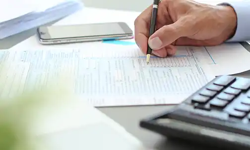 man jotting down his notes