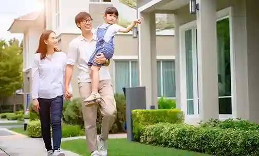 Couple with a kid walking through community of the new homes