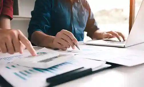 People reading and discussing the bar chart and related papers