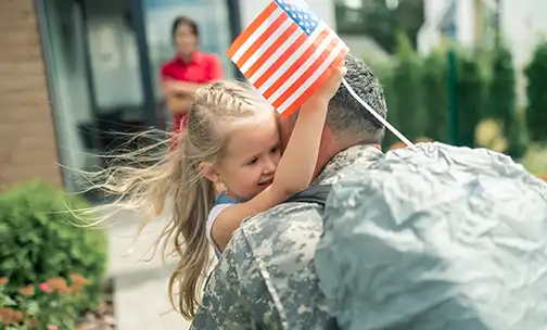 child hugging their military service member parent